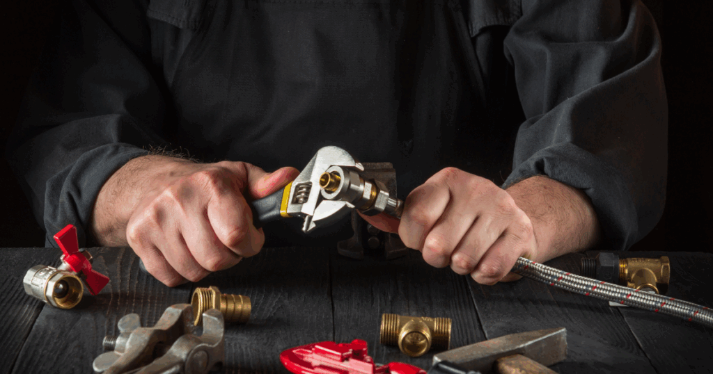 Licensed plumber performing safe gas line installation with wrench and fittings in Las Vegas