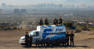 Fast Plumbing Las Vegas plumbing team with branded service van overlooking the city skyline